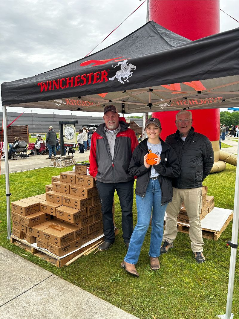 Two adults and one youth at the Winchester / White Flyer tent at the Mack’s Prairie Wings Youth Shooting Sports Trap Shoot & Shot Curtain Exhibit event